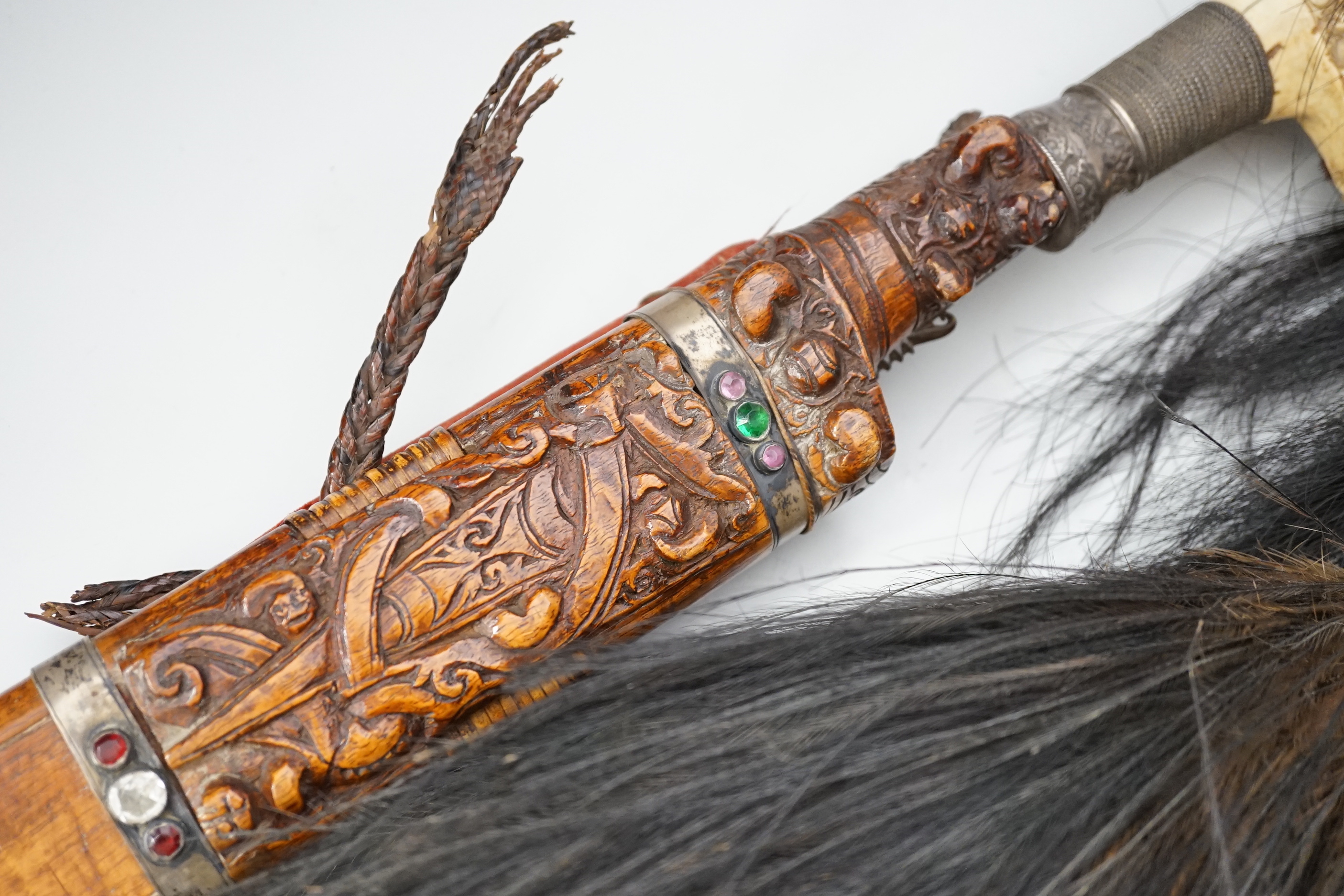 A Borneo 'headhunter's sword', a bone carving and feather swot (3), sword 77 cm long